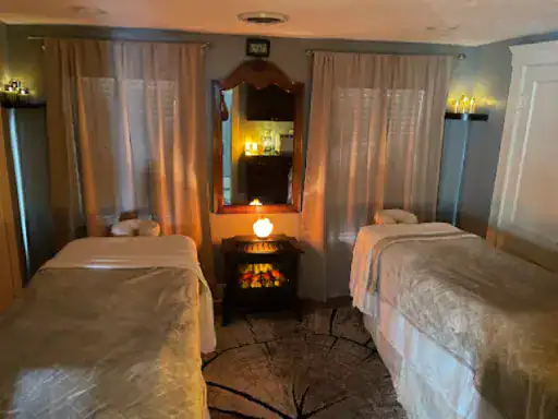 A peaceful spa room shows a relaxing place with two massage tables and warm lighting, highlighting the calm space above basement floors finished by J&P Coatings.