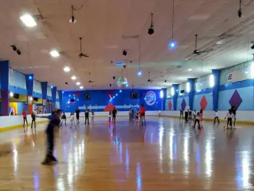 A lively roller skating rink with a smooth, well-maintained floor by J&P Coatings that’s perfect for skating fun.
