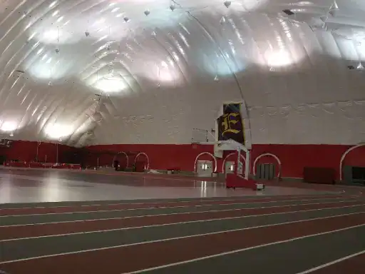A large indoor track facility completed by J&P Coatings shows a clean, professional space ready for sports events.