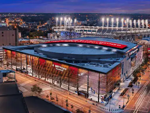 The image shows Rocket Mortgage FieldHouse, a key sports venue in a lively city. The scene highlights the area’s reputation for skilled flooring work, like that done by J&P Coatings.