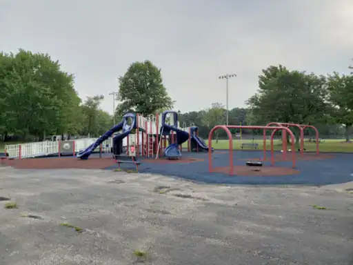 This image shows a clean and safe playground cared for by J&P Coatings. The play area is well-maintained and ready for children to enjoy.