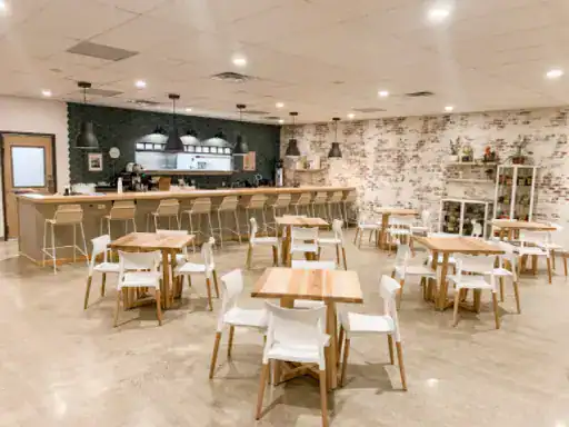 A bright, stylish cafe shows off new floors installed by J&P Coatings, giving the space a modern and welcoming feel.