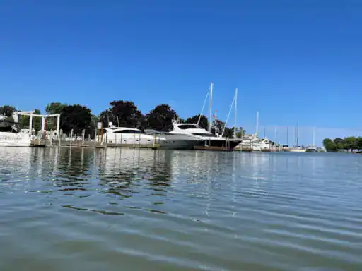 Boats and yachts rest in a peaceful marina, showing the smooth and lasting finish from J&P Coatings.