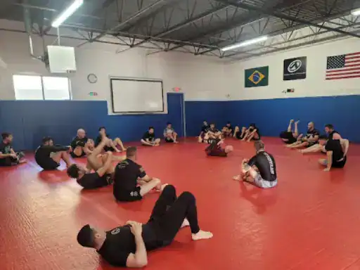People train together in Brazilian Jiu-Jitsu, showing both teamwork and focus. The scene shows off strong and skillfully finished basement floors by J&P Coatings.