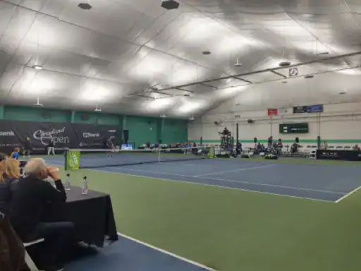 A tennis match takes place at the Cleveland Open, where J&P Coatings made the court surface. The bright venue hosts players and spectators for this exciting event. Alt text: Tennis match on a court finished by J&P Coatings at the Cleveland Open.