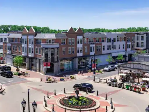 This image shows a busy shopping and apartment area with a plaza finished by J&P Coatings for strength and lasting use.