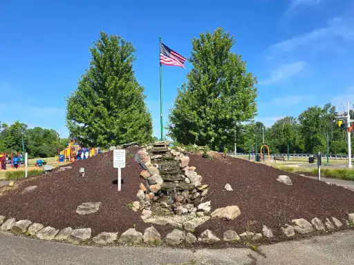 A welcoming outdoor space designed by J&P Coatings, featuring an American flag and family-friendly surroundings.