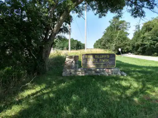 A sign for Erie Bluffs State Park shows visitors the entrance, with J&P Coatings helping keep surfaces safe and looking their best nearby.