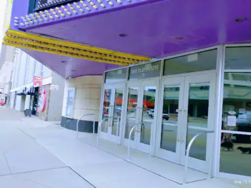 The image shows a city theater entrance with new coating work done by J&P Coatings, showing a fresh and welcoming look.