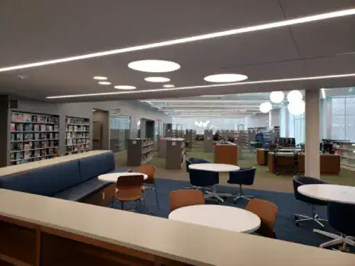 A modern library feels welcoming and bright, with polished floors by J&P Coatings making the space look clean and comfortable.
