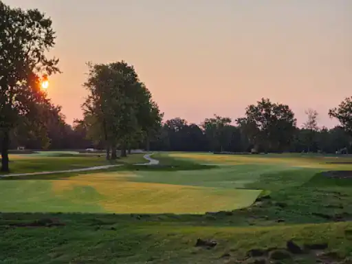 This image shows a calm golf course at sunset, giving a relaxing mood that inspires outdoor spaces. Perfect for J&P Coatings to show how their concrete patio finishes can help create peaceful backyard areas.