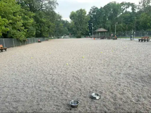 A relaxing dog park with benches and a gazebo shows how J&P Coatings can create welcoming outdoor spaces.