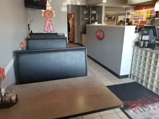 This image shows a clean, quiet restaurant by J&P Coatings. The space looks prepared for customers, showing a comfortable dining area and an easy way to order food.