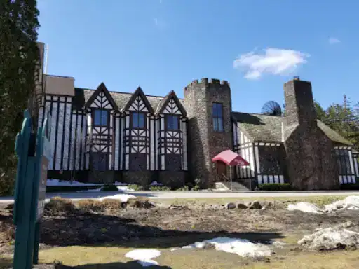 A classic Tudor-style home shows how J&P Coatings delivers trusted flooring for basements in traditional houses. Alt text: J&P Coatings provides expert basement flooring for traditional Tudor homes.