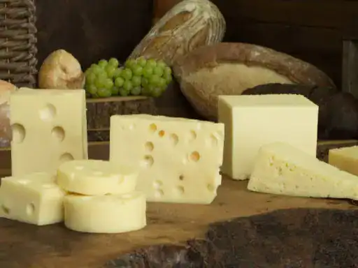 A selection of cheeses is shown in a way that highlights a sense of comfort and quality, much like the expert finishes provided by J&P Coatings.