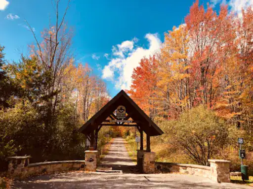 A welcoming entrance leads to a colorful autumn path, showing how J&P Coatings can improve outdoor areas.
