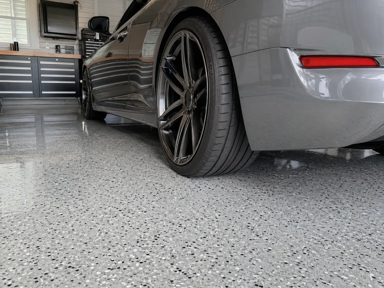 A J&P Coatings epoxy garage floor shows a clean, safe space for parking and keeping things organized.