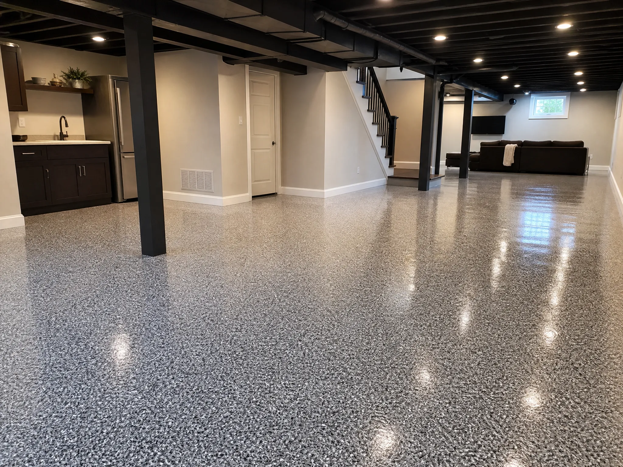 A welcoming basement updated by J&P Coatings, perfect for relaxing, watching TV, or spending time with family and friends.