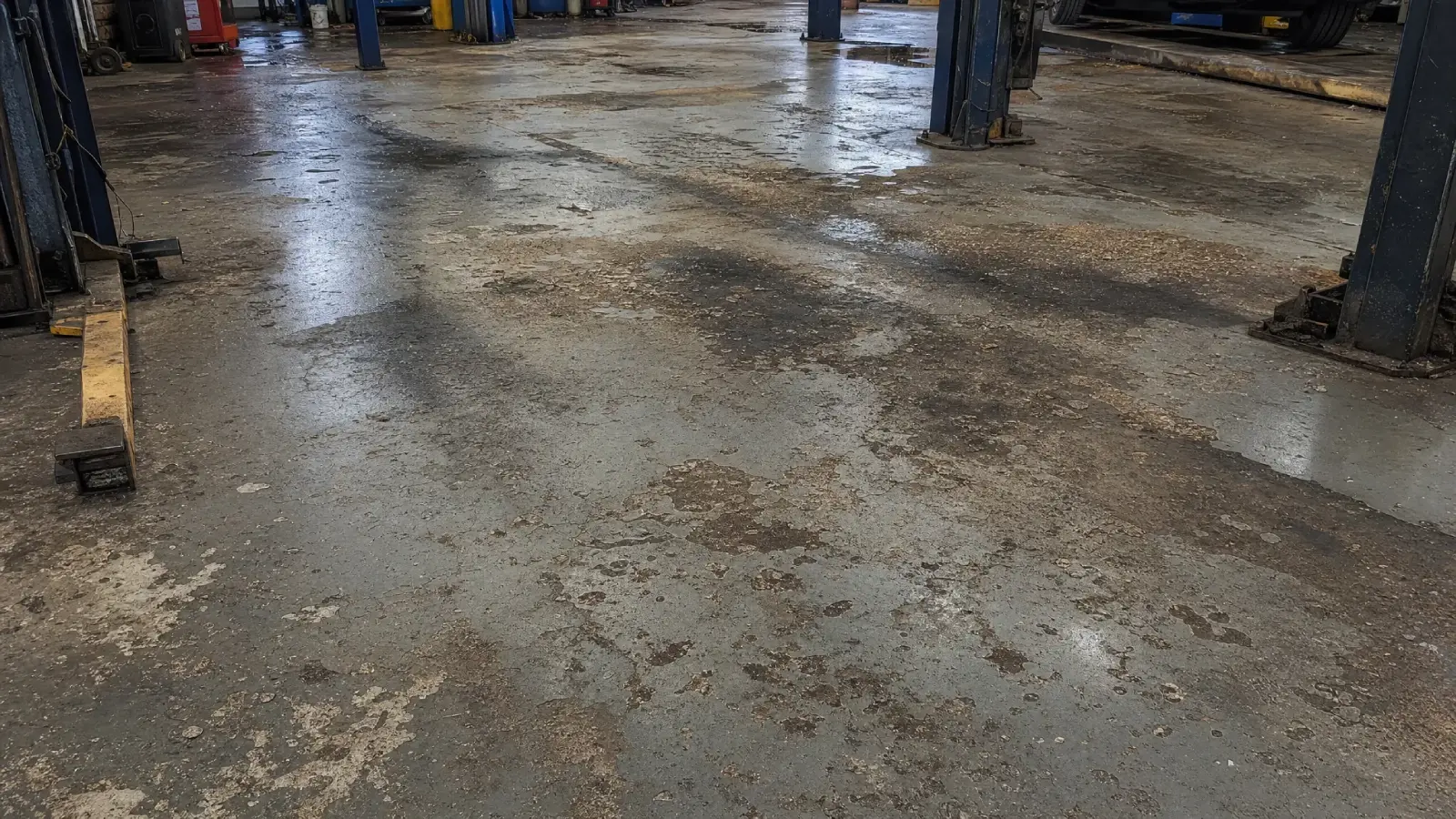 J&P Coatings shows an old, dirty shop floor that needs repair to make it safer and cleaner for workers and cars.