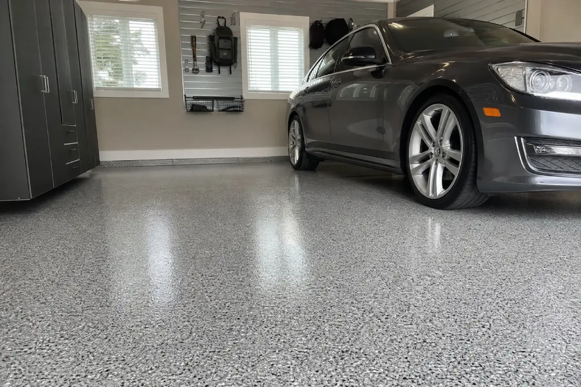 J&P Coatings shows an organized garage with neat storage and a clean, speckled epoxy floor for a tidy look.