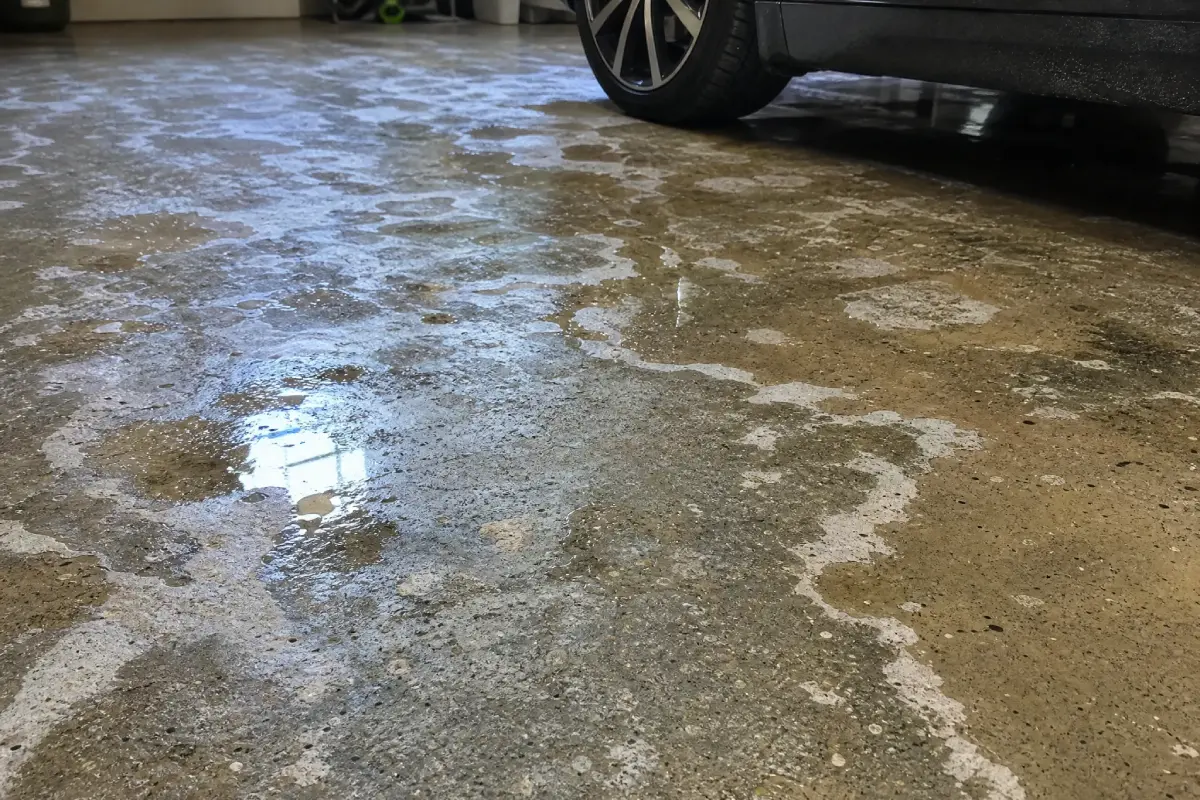 A J&P Coatings garage floor is being cleaned, showing its ability to handle water and keep surfaces safe.