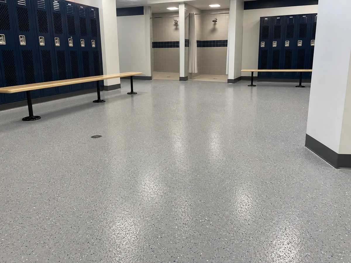 A fresh, well-lit J&P Coatings locker room shows a tidy space ready for teams to use, with showers in the back.